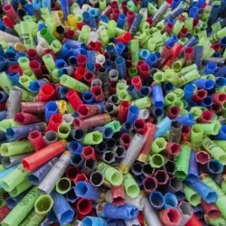 Image of spent shotgun shells with varying colours in a pile